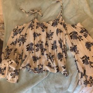 White Cold-Shoulder blouse with blue flowers.